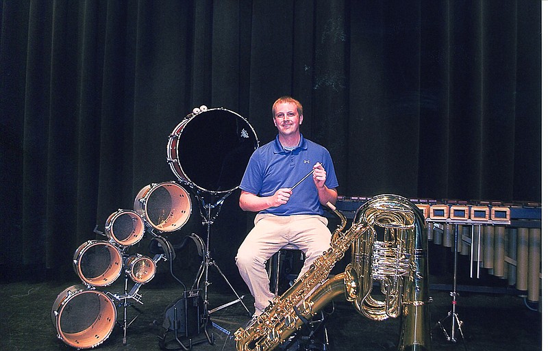 Dustijn Hollon, CHS Director of Bands, sits in the midst of the new band instruments.