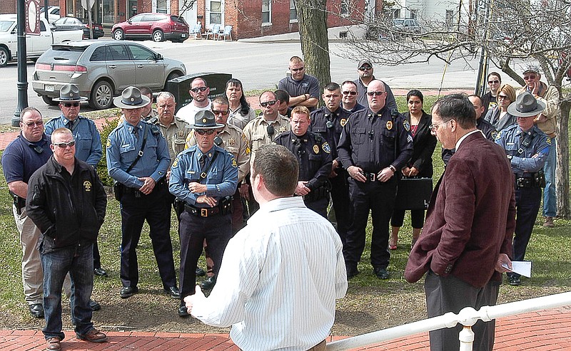 Law enforcement officers listen to the message being brought by Eddie Schoeneberg, Main Street Baptist Pastor, at the "Salute to Police" event held at the Moniteau County Courthouse at noon, Wednesday, March 25.