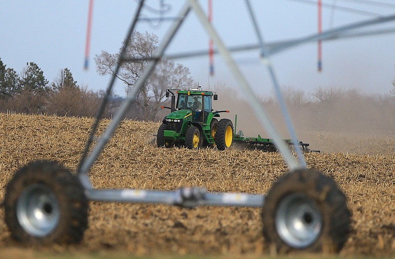 A farmer tills a field near Mead, Neb. The USDA released its annual prospective planting report on Tuesday, outlining farmer decisions about how much land to dedicate to corn, soybeans and other major crops including wheat and cotton. 