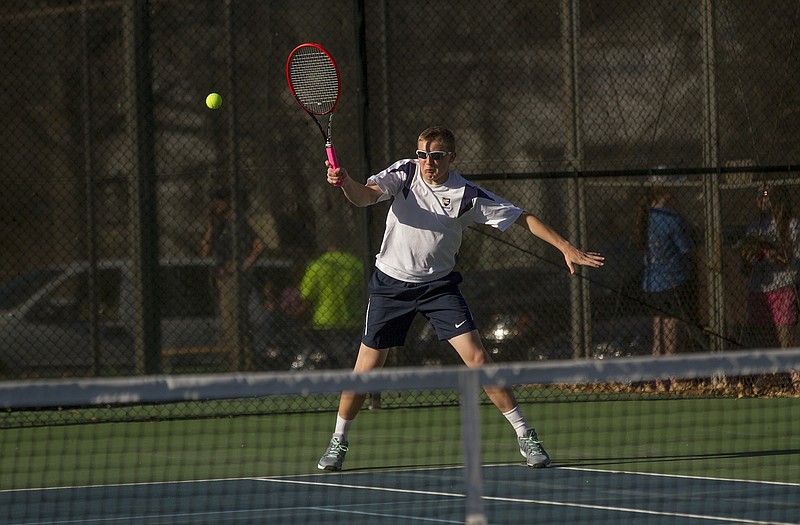 Helias' T.J. Hagenhoff returns a serve during the No. 1 doubles match in Tuesday's dual with Battle at Washington Park.