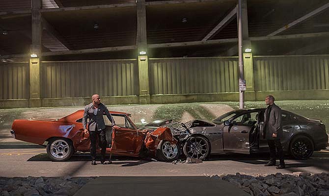 This photo provided by Universal Pictures shows, Vin Diesel, left, as Dom Toretto, and Jason Statham as Deckard Shaw, in a scene from "Furious 7." 