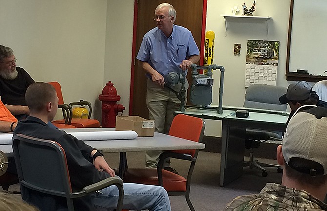 Dennis Bennett, Ameren Missouri supervisor of damage prevention and public awareness for gas operations, demonstrates how to operate a natural gas meter for firefighters with the Russellville-Lohman Fire Protection District.