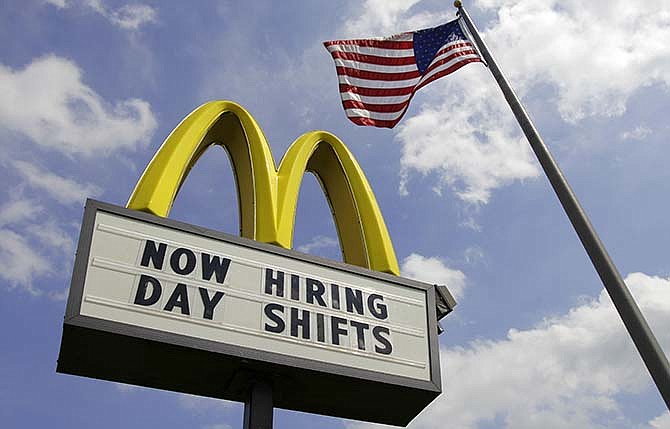This May 2, 2012, file photo shows a sign advertising job openings outside a McDonalds restaurant in Chesterland, Ohio. McDonald's on Wednesday, April 1, 2015 said it's raising pay for workers at its company-owned U.S. restaurants, making it the latest employer to sweeten worker incentives in an improving economy.