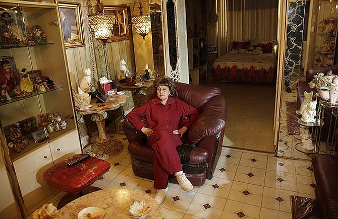 Adele Sarno poses for picture in her apartment in the Little Italy section of Manhattan, Tuesday, March 31, 2015, in New York. A fight in Manhattan's Little Italy neighborhood between a landlord who wants a tenant out and a tenant who doesn't want to go isn't just the run-of-the-mill New York City real estate struggle. The landlord is a museum dedicated to the legacy of Italian Americans in the area. The tenant? Sarno, an 85-year-old Italian American woman, who's lived there for more than 50 years.