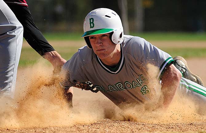 Adam Schell of Blair Oaks dives back into the bag at first to beat the tag of Lee's Summit North first baseman Andrew Kleiboeker on a pickoff attempt Saturday at Vivion Field in Jefferson City.