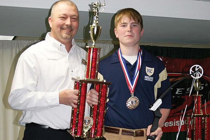 Helias freshman Seth Pezley was the top male archer at the 2015 Missouri National Archery in the Schools state tournament. He is pictured with MoNASP coordinator Eric Edwards. Pezley received a trophy and a special-edition prize bow from the National Archery in the Schools Program.