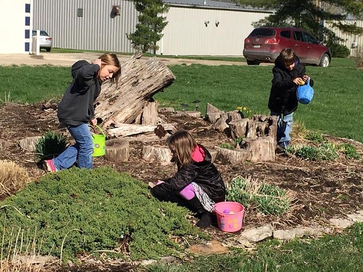 Aubree Hedgpeth, Kate Crews and Tristan Ewers search for eggs at the Prairie Home Community Easter Egg Hunt on Saturday.