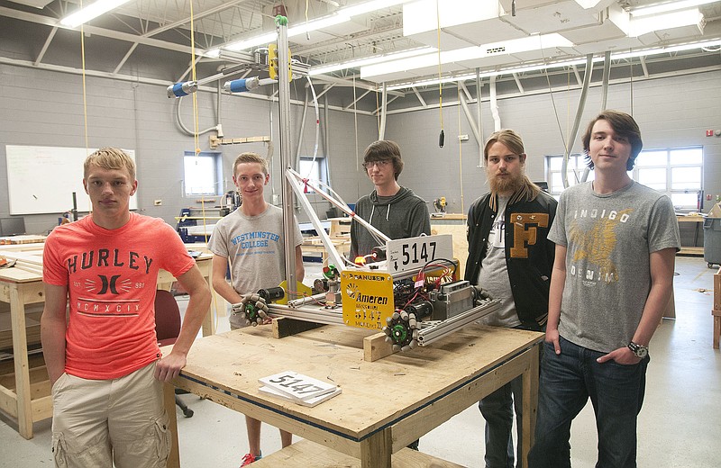 Members of the Fulton High School robotics club pose for a photo next to their robot on Wednesday. From left: Martin Morard, Trask Crane, Hollis Long, Alex Zajdel and Hayden Long. The robotics club is in its second year at the high school.