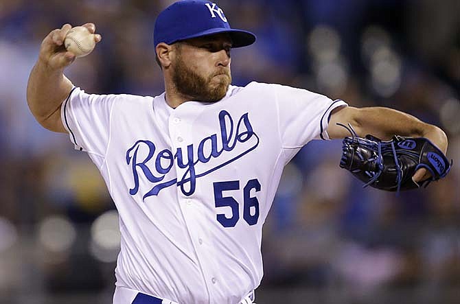 Kansas City Royals relief pitcher Greg Holland delivers to a Chicago White Sox batter during the ninth inning of a baseball game at Kauffman Stadium in Kansas City, Mo., Wednesday, April 8, 2015. The Royals defeated the White Sox 7-5. 