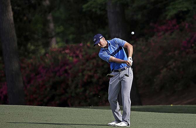 Jordan Spieth hits a chip shot during the first round of the Masters golf tournament Thursday, April 9, 2015, in Augusta, Ga.