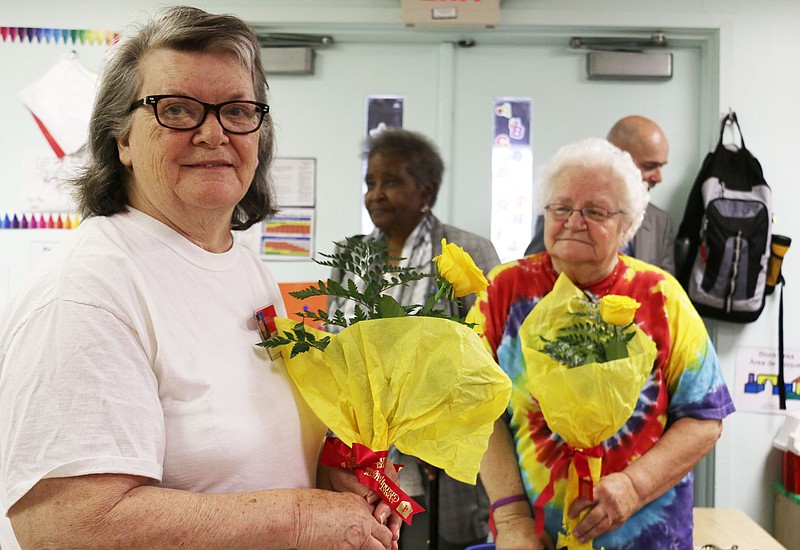 Leora Walling and other volunteers receive flowers at HeadStart in Fulton on Wednesday - Mayors Day of Recognition for National Service. Walling has volunteered with the Foster Grandparent Program for eight years.