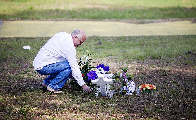 Jeffrey Spell, of Charleston, South Carolina, places flowers at the scene where Walter Scott was killed by a North Charleston police officer Saturday, after a traffic stop April 9. "I've worked in North Charleston for many years and I'm troubled by the whole thing. I thought it would be respectable," said Spell about why he brought the flowers.