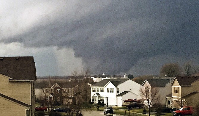 In this photo provided by Emily Mains, a tornado is viewed near Pearl Street from a home in the Kennedy's subdivision in Kirkland, Ill., on Thursday, April 9, 2015. One person was killed in the tiny community of Fairdale, James Joseph with the Illinois Department of Emergency Management said.