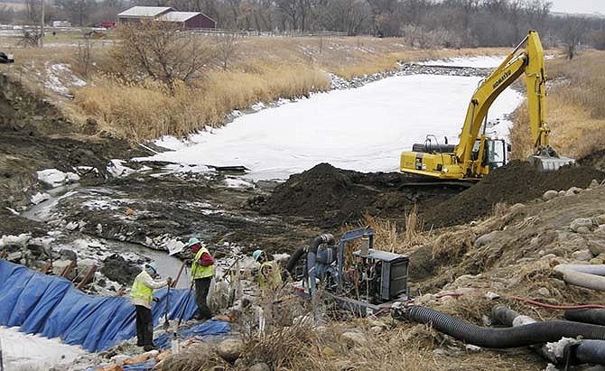 In this Jan. 15, 2008 file photo, workers finish placing pipeline for the Northwest Area Water Supply (NAWS) project through the Souris River near Minot, N.D. North Dakota officials believe a federal study of the large Missouri River water project in the state has adequately addressed fears of environmental harm in the state of Missouri and the Canadian province of Manitoba. However, they're still resigned to the likely continuation of a drawn-out legal fight that has already delayed the NAWS project for more than a decade. 