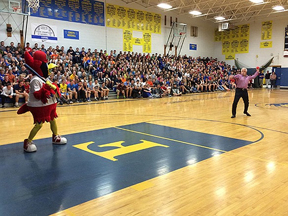 Former St. Louis Cardinals reliever, Al Hrabosky, prepares to deliver a pitch Tuesday to Fredbird during a visit to Fatima High School.