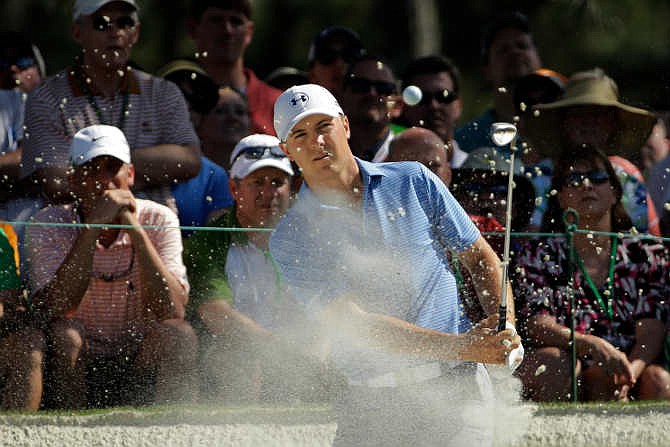Jordan Spieth watches his hit out of a bunker at the seventh hole during the third round of the Masters golf tournament Saturday, April 11, 2015, in Augusta, Ga. 