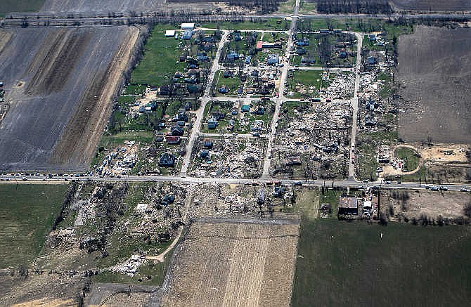 This aerial photo shows a path of destruction Friday, April 10, 2015, after a tornado swept through the small town of Fairdale, Ill., in DeKalb County Thursday night. The National Weather Service says at least two tornadoes churned through six north-central Illinois counties. Illinois Gov. Bruce Rauner declared DeKalb and Ogle counties affected by the severe storms and tornadoes as disaster areas. (AP Photo/Daily Chronicle, Danielle Guerra)