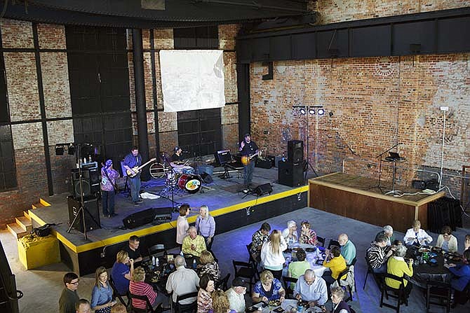 Those attending the Discover Jefferson City Foundation's sold-out Mill Around the Millbottom event Thursday in the old Missouri Power and Light Building enjoy catered food, drinks, and the sounds of local band Mother's Basement in the renovated brick building, which is located west of the Missouri Capitol.
