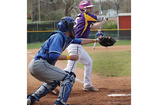 Fatima catcher Zach Hudspeth is in position as Eureka's Bo Highfill swings during Saturday's game at Vivion Field in Jefferson City.