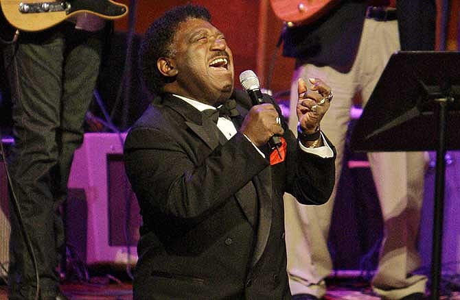 In this Oct. 28, 2008 file photo, Percy Sledge kneels as he performs "When a Man Loves a Woman" along with the Muscle Shoals Rhythm Section at the Musicians Hall of Fame awards show in Nashville, Tenn. Sledge, who recorded the classic 1966 soul ballad "When a Man Loves a Woman," died, Tuesday April 14, 2015. He was 74.