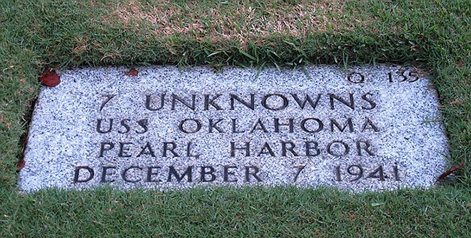 A gravestone identifying the resting place of seven unknowns from the USS Oklahoma is shown at the National Memorial Cemetery of the Pacific in Honolulu. The Pentagon says it will disinter and try to identify the remains of up to 388 unaccounted for sailors and Marines killed when the USS Oklahoma sank in the 1941 Japanese bombing of Pearl Harbor.