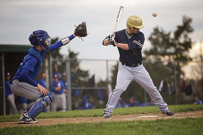 
Helias'
Will
Blankenship
ducks
his helmet
to
avoid
getting
hit by
a wild
pitch
during
Tuesday
night's
game
with
Moberly
at the
American
Legion
Post 5
Sports
Complex.