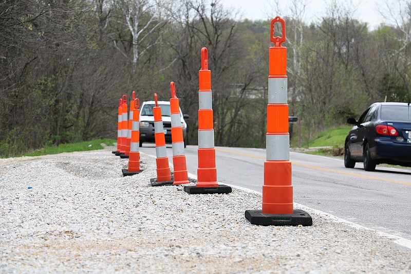 Cars drive down Mokane Road near a damaged spot on the road, which Missouri Department of Transportation crews have been keeping a special eye on since May 2014.
