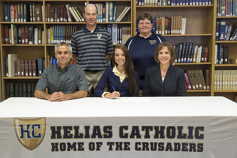 Kile Brewer/News Tribune
Kaitlyn Shea of Helias High School signs a letter of intent Wednesday to run track and cross country at Southeast Missouri State University. Also seated are her parents, Mike and Lynne Shea. Standing (from left) are Helias assistant track coach Brad Hake and head cross country coach Mary Haskamp.