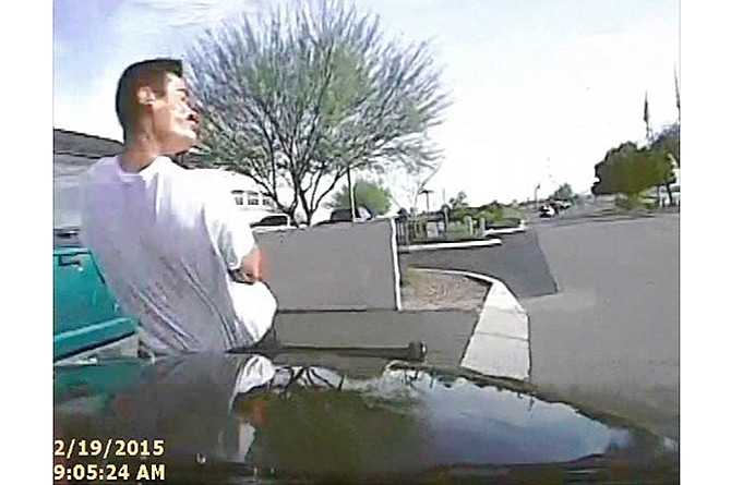 In this Feb. 19, 2015, frame grab from a dash cam video provided by the Marana Police Department, a police vehicle hits Mario Valencia in Marana, Ariz. Dramatic dash cam video released Tuesday, April 14 shows a police officer using his cruiser to ram the armed suspect, Valencia, sending him flying in the air before the car smashes into a wall. Valencia survived the crash, and prosecutors cleared the officer of any wrongdoing. 