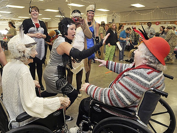 Frankie Meller, right, receives a high-five from Jeanne White as she reaches the finish line in the wheelchair race during Thursday's Golden Age Games at the St. Martins Knights of Columbus. Elizabeth Hicock, at left, was at the line to cheer on Meller during the heat race. Residents enjoyed a "blast from the past" as they competed in this year's games themed "Living Throughout the Decades."