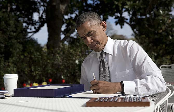 President Barack signs the bill H.R. 2 Medicare Access and CHIP Reauthorization Act of 2015, Thursday, April 16, 2015, in the Rose Garden of the White House in Washington. The president signed legislation permanently changing how Medicare pays doctors, a rare bipartisan achievement by Democrats and Republicans. The bill overhauls a 1997 law that aimed to slow Medicare's growth by limiting reimbursements to doctors. Instead, doctors threatened to leave the Medicare program, and that forced Congress repeatedly to block those reductions.