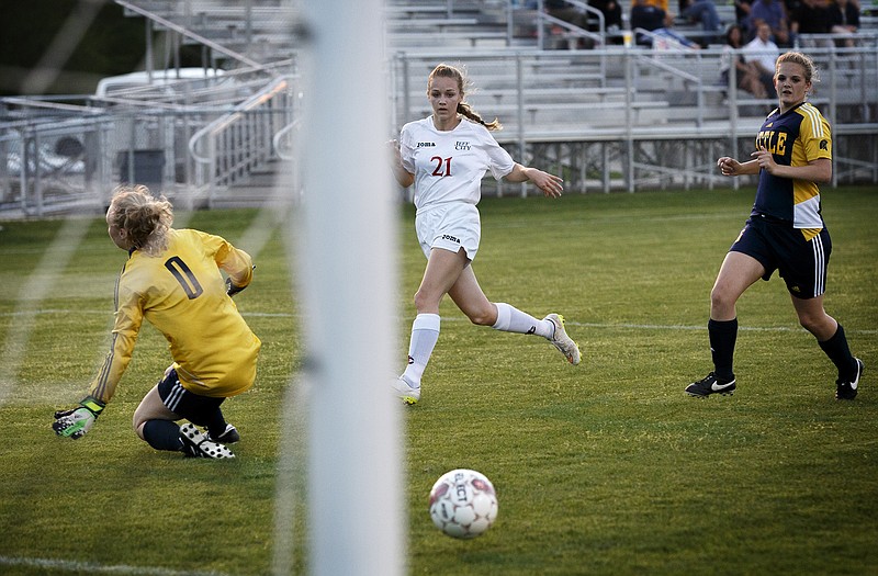 Sarah Luebbert of Jefferson City watches her shot go toward the net for a goal during Thursday night's contest against Battle at the 179 Soccer Park.