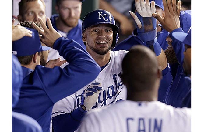 Kansas City Royals' Paulo Orlando celebrates after scoring on a sacrifice fly by Omar Infante during the eighth inning of a baseball game against the Oakland Athletics, Friday, April 17, 2015, in Kansas City, Mo. 