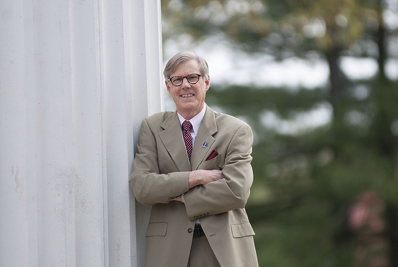 Westminster College President Barney Forsythe poses for a photo at the Westminster Columns on Friday. After 10 years in various roles at the college, Forsythe will retire at the end of the academic year as its president.