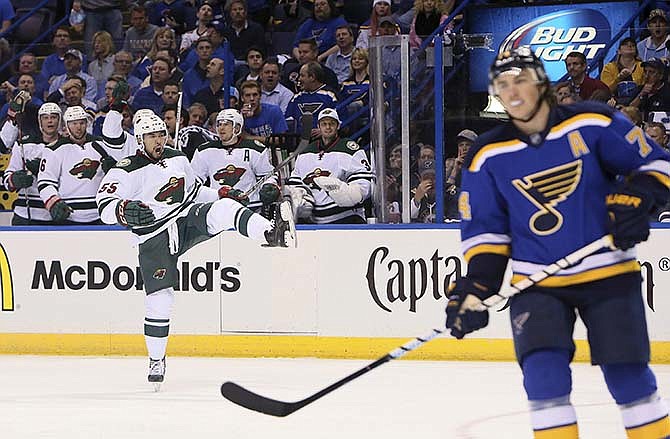 Minnesota Wild defenseman Matt Dumba celebrates after scoring during the second period against the St. Louis Blues in Game 1 of an NHL hockey first-round playoff series, Thursday, April 16, 2015, in St. Louis. At right is Blues' T.J. Oshie.