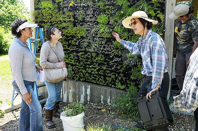 Associate Professor Hwei-Yiin Johnson, right, talks about the green wall in 2013 during her presentation about ways to grow using composted or organic soils. Lincoln University land-grant funding helps pay for research that seeks ways to improve small business and agricultural operations. LU operates two research farms in Cole County - the Carver Farm on Bald Hill Road and the Busby Farm on Goller Road, east of U.S. 54 South.