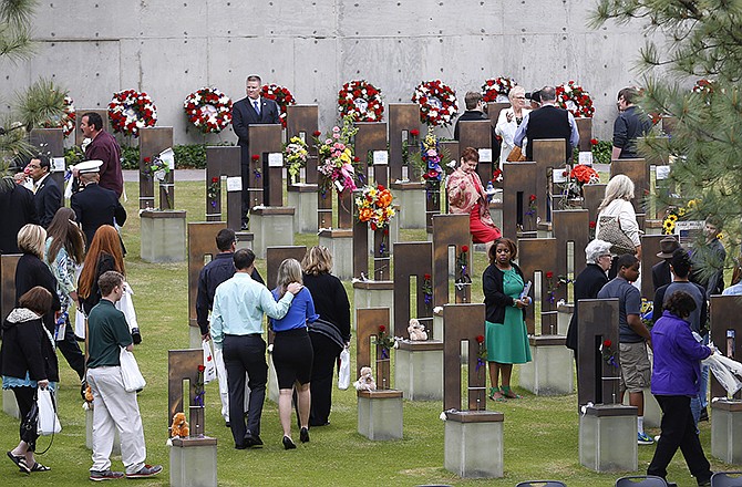 People move into the Field of Empty Chairs where bombing victims are memorialized, following a ceremony Sunday for the 20th anniversary of the Oklahoma City bombing at the Oklahoma City National Memorial in Oklahoma City. 