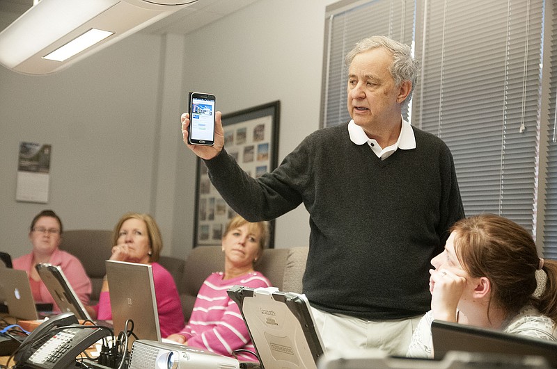 Tom Woolsey, CEO of Utility Software Solutions, Inc., shows city of Fulton employees how to access the electrical usage website on Tuesday during a training session on the new system.