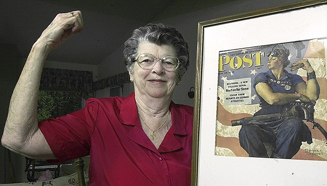 Mary Doyle Keefe poses in 2002 at her home in Nashua, New Hampshire, with the May 29, 1943, cover of the Saturday Evening Post for which she had modeled as "Rosie the Riveter" in a Norman Rockwell painting. Keefe died Tuesday in Simsbury, Connecticut, after a brief illness. 