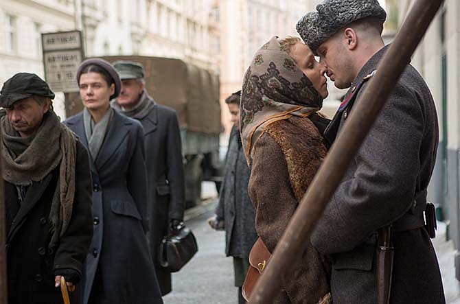 In this image released by Lionsgate, Noomi Rapace, second right, and Tom Hardy appear in a scene from the film, "Child 44."