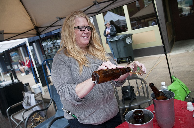 Amy Stone-Bowers, a Fulton-based home brewer, pours a sample of her beer on Saturday, April 25, 2015 at the Morels and Microbrews festival in Fulton, sponsored by the Brick District. It was the first year the event featured home brewers. 