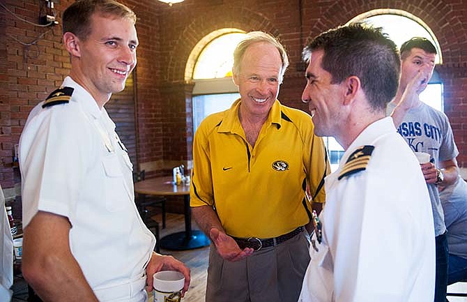 Columbia, Mo., mayor Bob McDavid, center, speaks with Navy Lt. Jason Ulbrich, left, and Cmdr. Patrick Friedman during an informal welcoming reception Saturday at Shiloh Bar and Grill. Ulbrich and Friedman are from the Pearl Harbor-based USS Columbia (SSN771) Los Angeles class nuclear submarine. (Daniel Brenner/Columbia Daily Tribune via AP)
