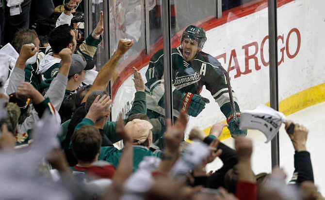 Minnesota Wild left wing Zach Parise reacts in front of the fans after scoring on St. Louis Blues goalie Brian Elliott during the third period of Game 6 of an NHL hockey first-round playoff series in St. Paul, Minn., Sunday, April 26, 2015. The Wild won 4-1 to win the series and advance to the second round.