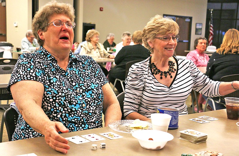 Carolyn Fisher and Betty Jennings laugh during a card game at the Callaway Community Hospital Auxiliary spring card party at the Callaway Electric Co-op Monday afternoon. The card party is one of the Auxiliary's main fundraisers. Proceeds go to the Auxiliary 's scholarship fund and items to enhance patient comfort at the hospital.