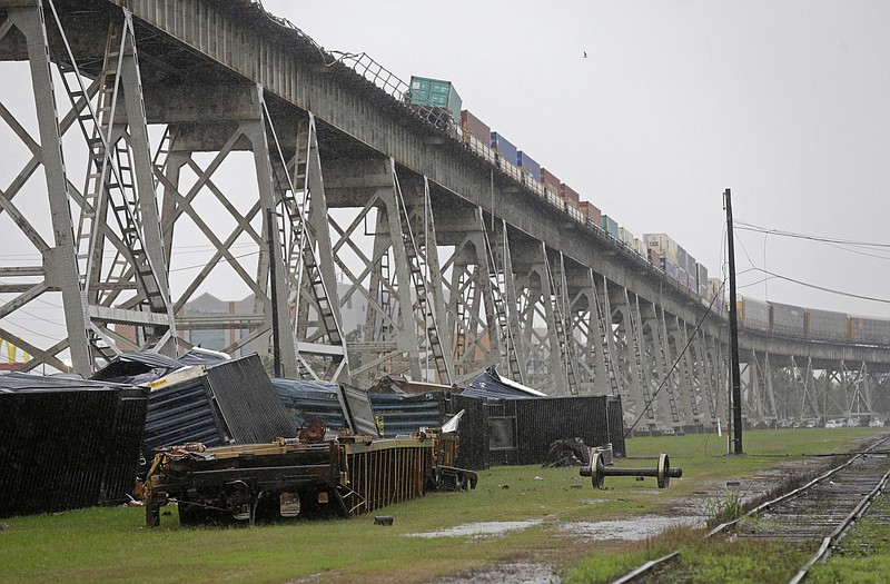 Train cars are seen beneath the Huey P. Long Bridge, which crosses over the Mississippi River, after they toppled off the bridge from high winds in Jefferson Parish, La., just outside New Orleans.