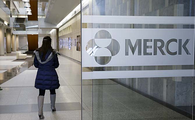 In this Thursday, Dec.18, 2014 photo, a person walks through a Merck & Co. building, in Kenilworth, N.J. Merck & Co. reported quarterly financial results before the market opened Tuesday, April 27, 2015.