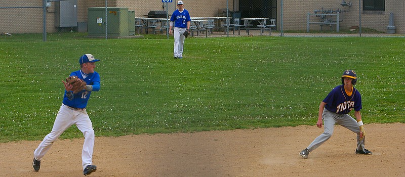 Shortstop, Garrett Wolfe, holds a runner at second after fielding a ground ball in Jamestown's 4-1 loss to Pilot Grove Friday, April 24. (Democrat photo/Camal Petro)