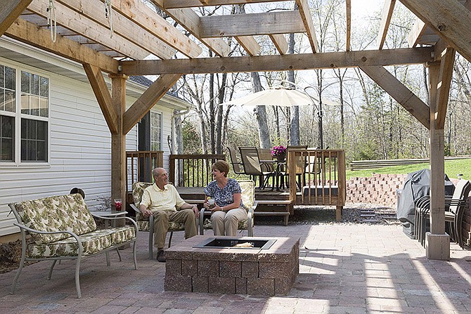 By adding a pergola, fire pit and some accessories, Bill and Cindi Dampf transformed their outdoor spaces into a patio fit to entertain their children and grandchildren. 