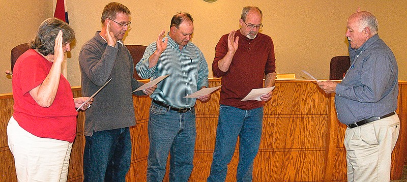 California City Clerk Brian Scrivner, far right, administers on Tuesday, April 21, the oath of office to, from left, returning Ward III Alderwoman Carol Rackers and Mayor Norris Gerhart, and first time Ward II Alderman Darryl Elliott and Ward I Alderman Ron Baker.