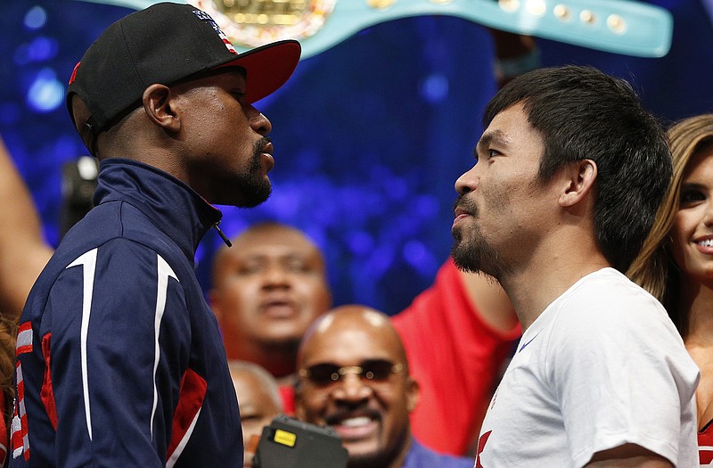 Floyd Mayweather Jr. and Manny Pacquiao pose during their weigh-in Friday in Las Vegas.